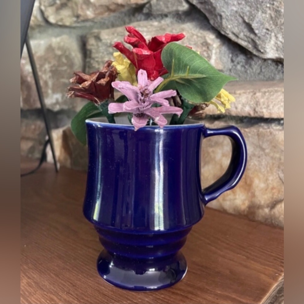 Real pinecones hand cut and painted, arranged in a ceramic cup.